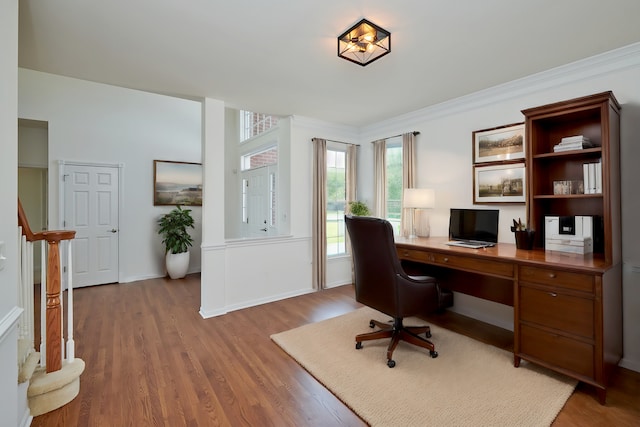 office area with ornamental molding and light hardwood / wood-style flooring