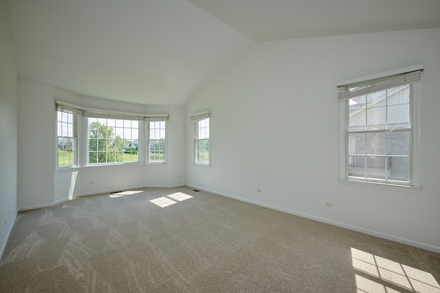 empty room with carpet flooring and vaulted ceiling