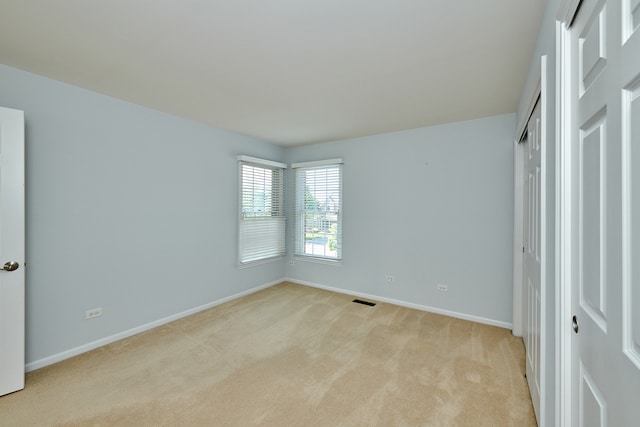 unfurnished bedroom with light carpet