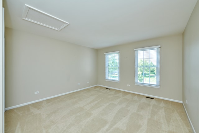 spare room with light colored carpet