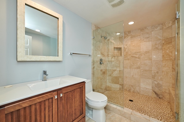 bathroom with vanity, toilet, an enclosed shower, and tile patterned flooring