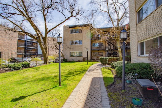 view of property's community featuring a yard