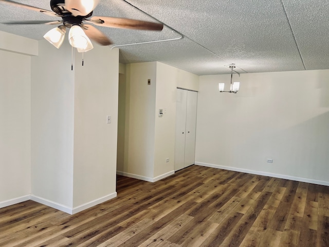 unfurnished room with a textured ceiling, ceiling fan, and dark wood-type flooring