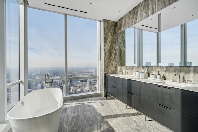 bathroom featuring a bathtub, hardwood / wood-style flooring, plenty of natural light, and vanity