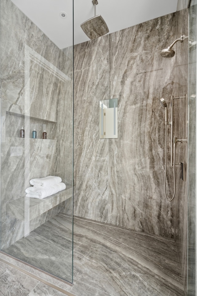 bathroom with tile walls and a tile shower