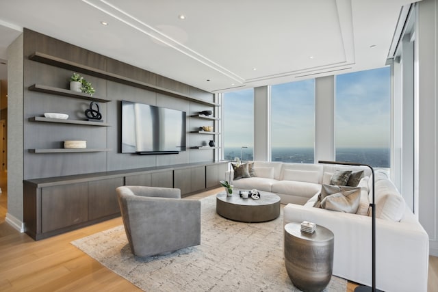 living room featuring light hardwood / wood-style flooring and a wall of windows