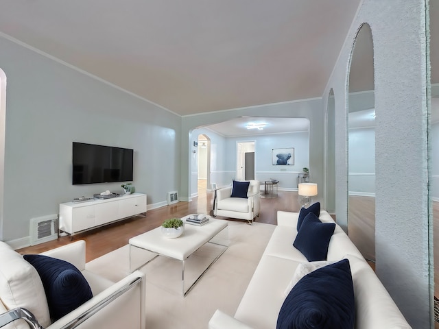 living room featuring ornamental molding and hardwood / wood-style floors