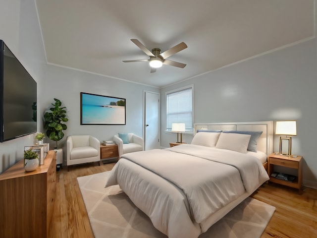 bedroom featuring hardwood / wood-style floors, ceiling fan, and ornamental molding