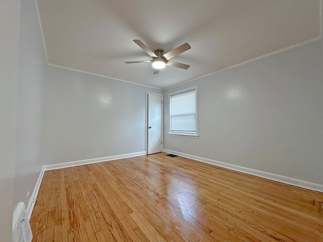 empty room featuring crown molding, light hardwood / wood-style flooring, and ceiling fan