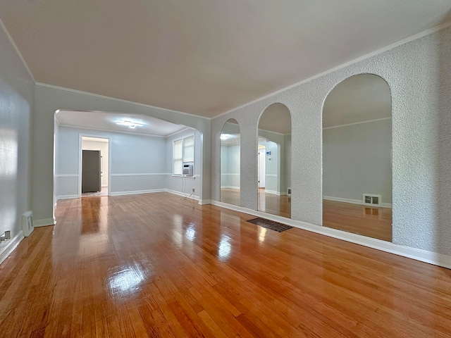 interior space with crown molding, hardwood / wood-style floors, and cooling unit