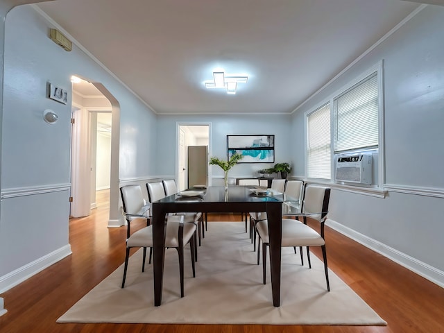 dining space with ornamental molding, hardwood / wood-style flooring, and cooling unit