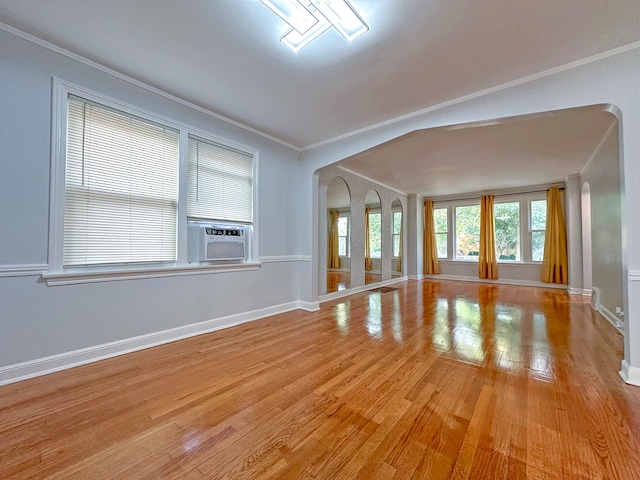 interior space with cooling unit, hardwood / wood-style floors, and crown molding