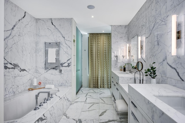 bathroom featuring tile patterned flooring, tile walls, a tub to relax in, and vanity