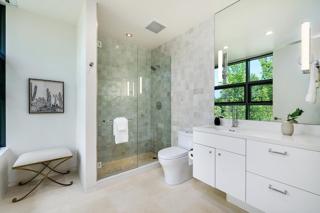 bathroom with vanity, toilet, an enclosed shower, and tile patterned floors