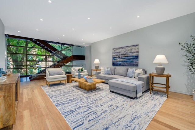 living room with light wood-type flooring and a wall of windows