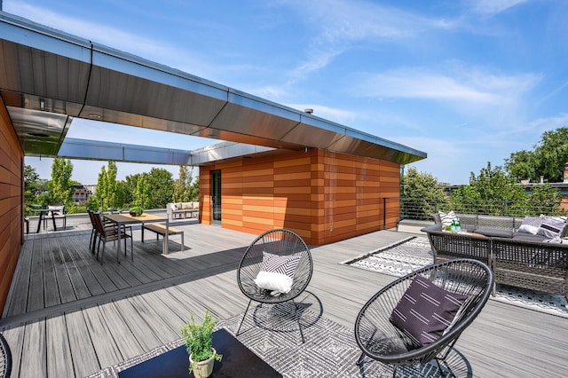 wooden terrace with an outdoor living space