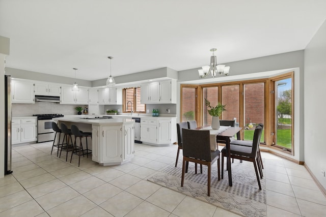 dining space with baseboards, light tile patterned flooring, and a notable chandelier