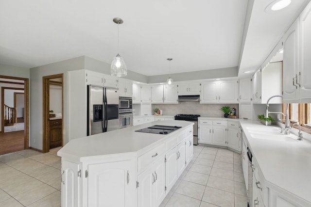 kitchen featuring a sink, appliances with stainless steel finishes, light tile patterned floors, and a kitchen island