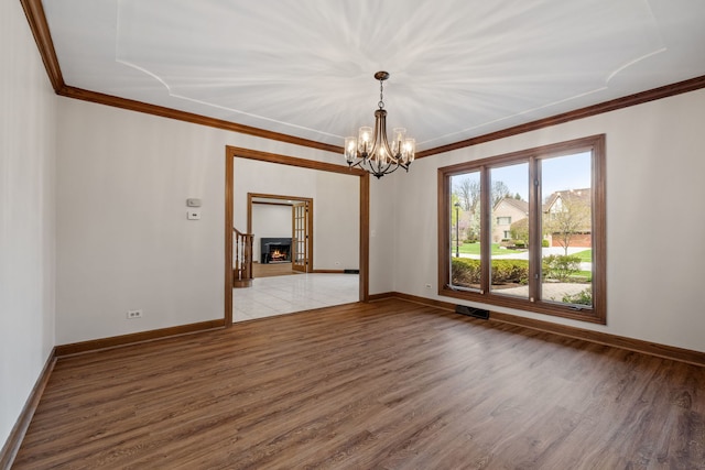 unfurnished room with a chandelier, ornamental molding, visible vents, and light wood-style floors