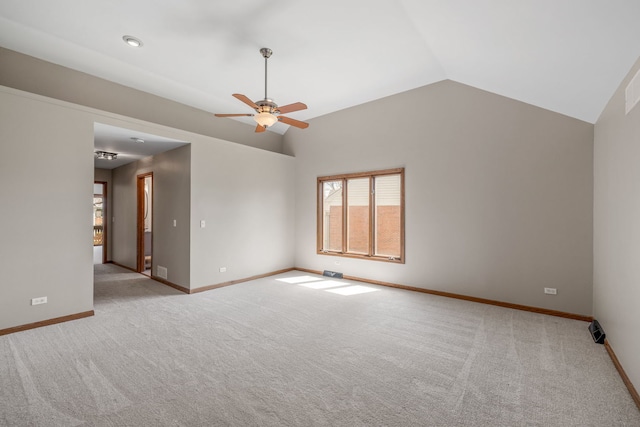 spare room featuring carpet floors, baseboards, ceiling fan, and lofted ceiling