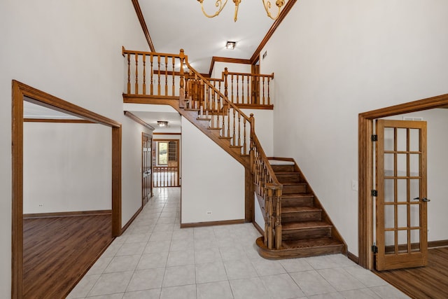 3944 Paradise Canyon Ct, Naperville, IL 60564 - stairway featuring crown molding, baseboards, tile patterned flooring, and a towering ceiling