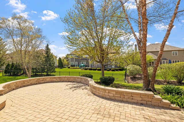 surrounding community featuring a lawn, fence, and a patio