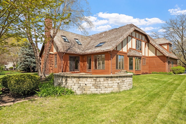 rear view of house with a yard and a chimney