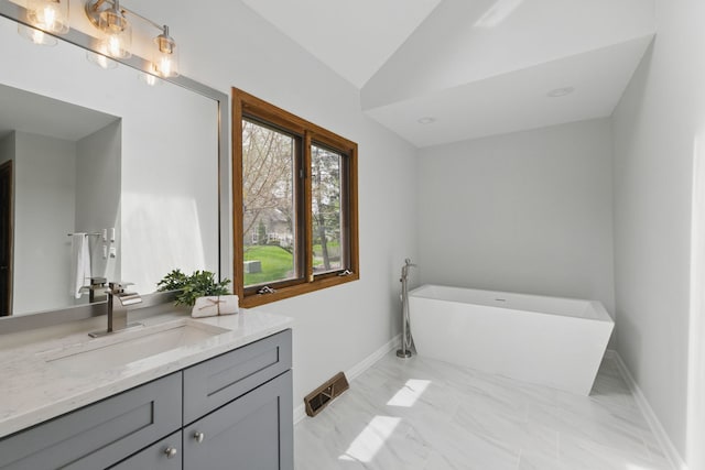 3944 Paradise Canyon Ct, Naperville, IL 60564 - full bath featuring a freestanding tub, vaulted ceiling, vanity, baseboards, and marble finish floor