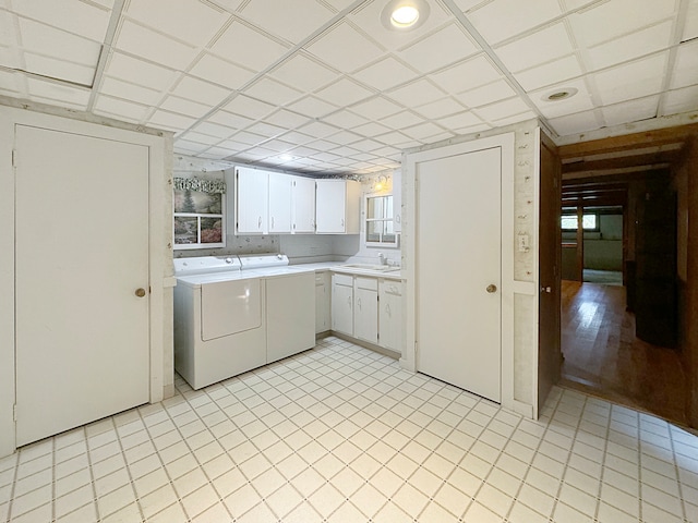 laundry area featuring light hardwood / wood-style flooring, cabinets, and washer and dryer