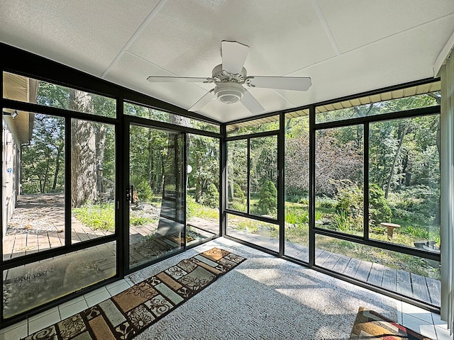 unfurnished sunroom with ceiling fan