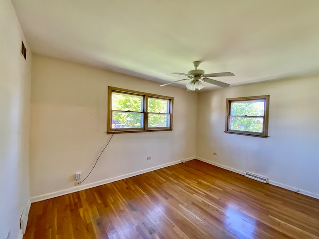 unfurnished room featuring hardwood / wood-style floors and ceiling fan