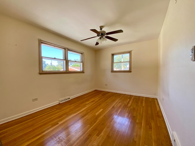 empty room featuring ceiling fan and hardwood / wood-style floors