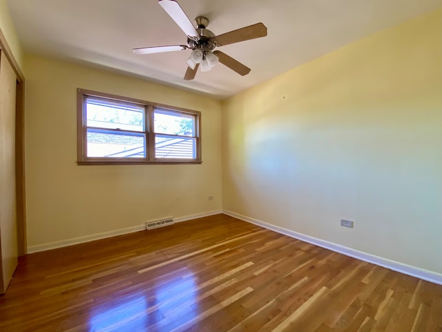 spare room featuring hardwood / wood-style floors and ceiling fan