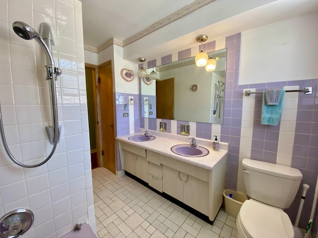 bathroom with vanity, backsplash, tile walls, toilet, and tile patterned floors