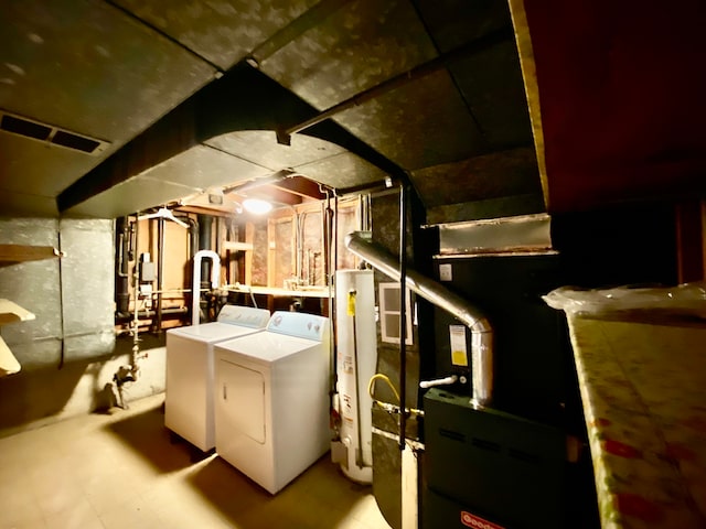 utility room featuring gas water heater and separate washer and dryer