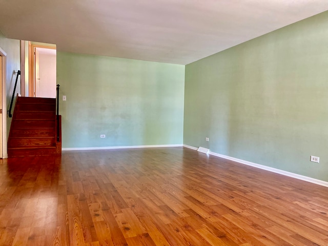 unfurnished room with hardwood / wood-style flooring