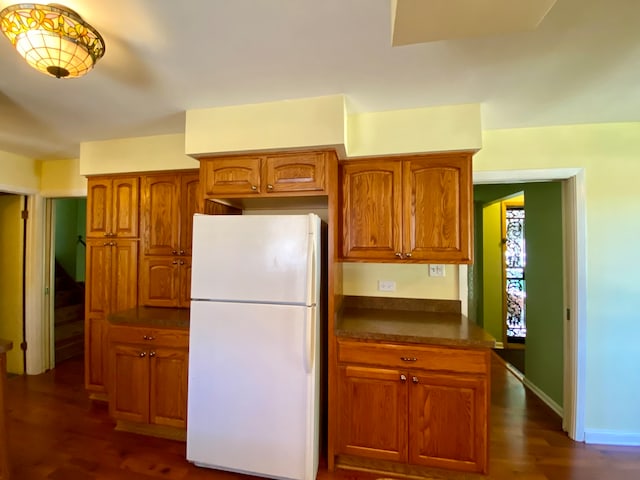 kitchen featuring white fridge and dark hardwood / wood-style flooring