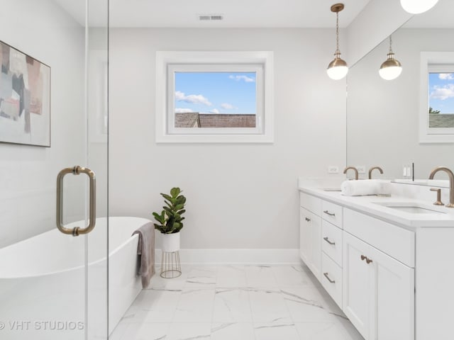 bathroom featuring vanity and a tub