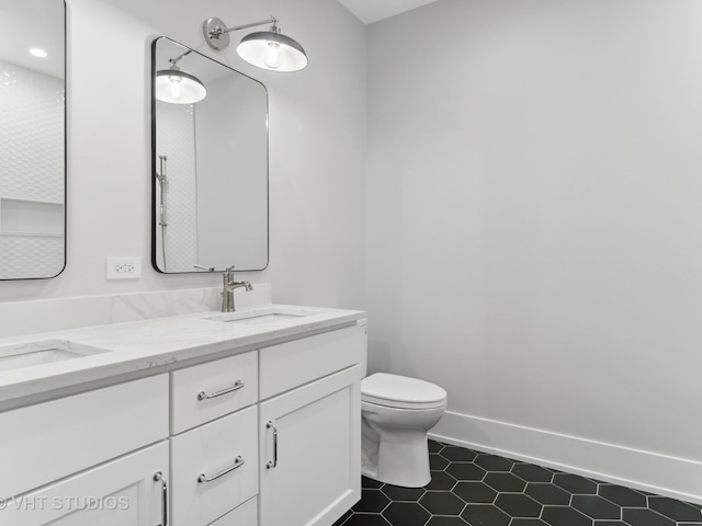 bathroom featuring vanity, toilet, and tile patterned floors