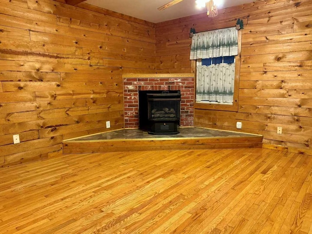 unfurnished living room featuring wood walls and light hardwood / wood-style floors