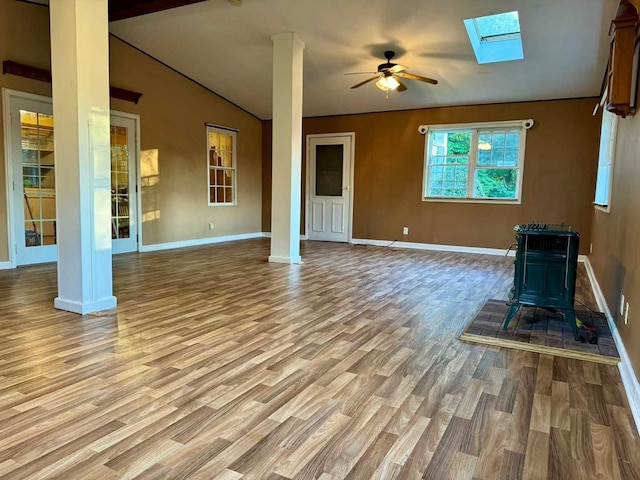 unfurnished living room featuring ceiling fan, light hardwood / wood-style flooring, and lofted ceiling with skylight