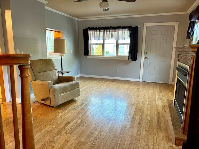 sitting room with crown molding, light hardwood / wood-style floors, and ceiling fan