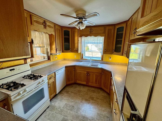 kitchen with white appliances, ceiling fan, and sink