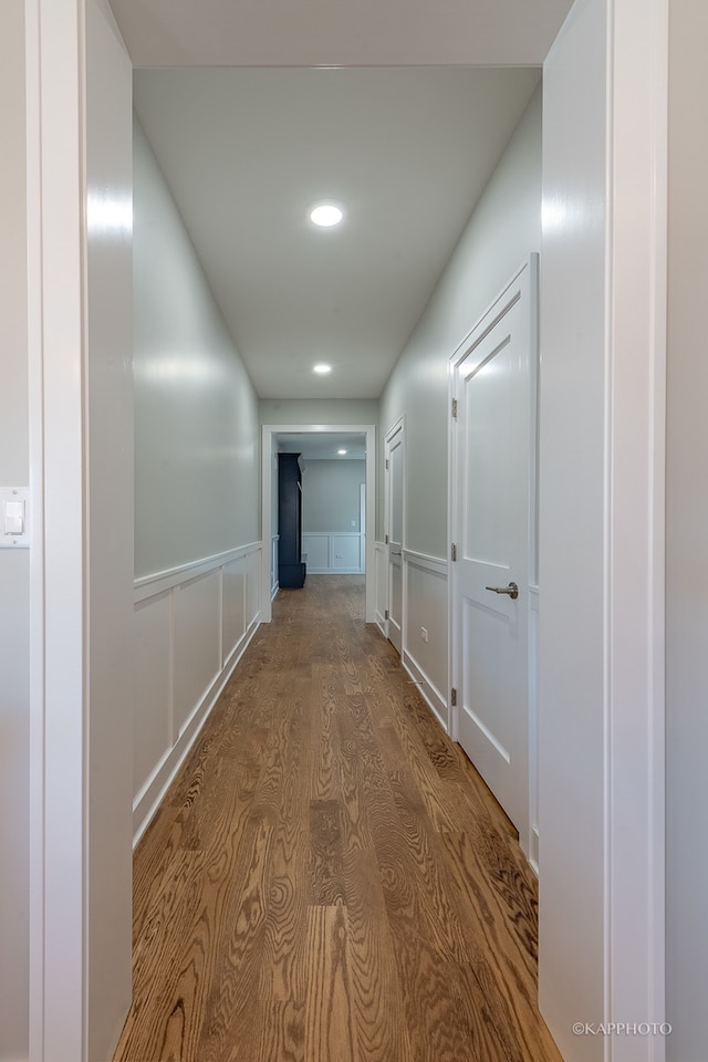 corridor with wood-type flooring