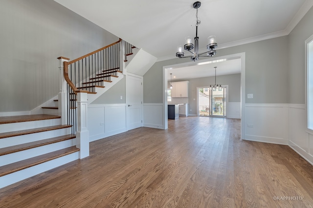 interior space with crown molding, a chandelier, and hardwood / wood-style floors