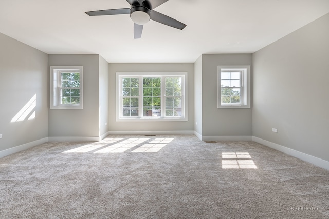 empty room with ceiling fan and light colored carpet