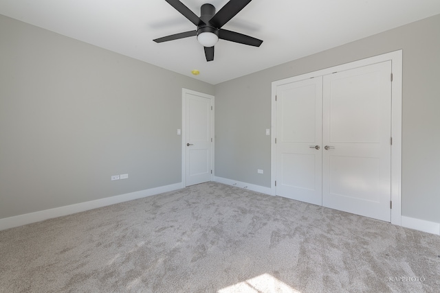 unfurnished bedroom featuring a closet, ceiling fan, and light carpet