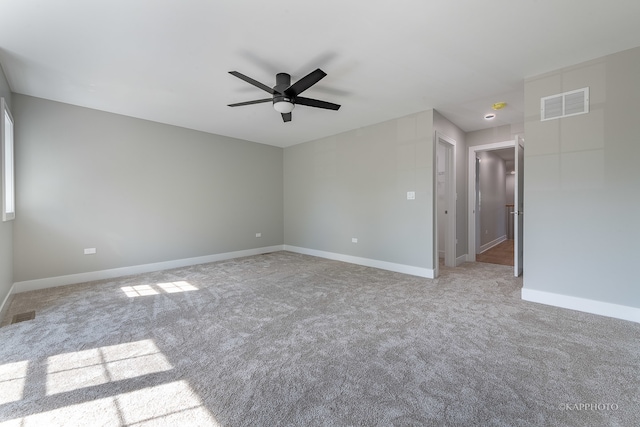 carpeted spare room with ceiling fan