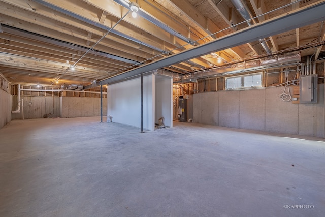 basement featuring water heater and electric panel