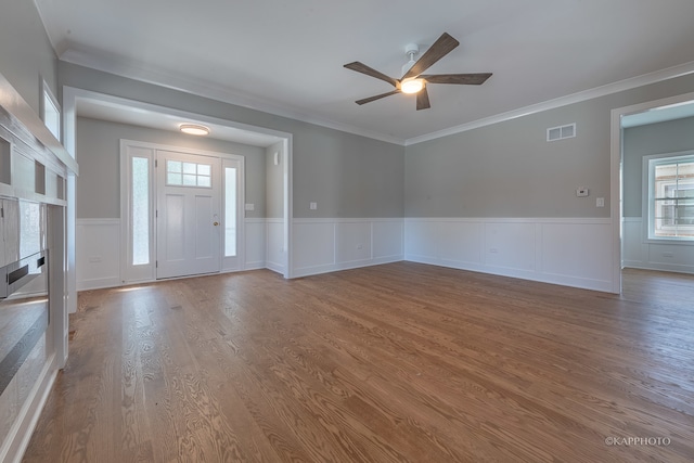 interior space with ornamental molding, hardwood / wood-style floors, and ceiling fan